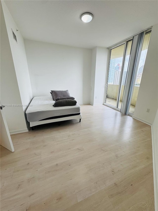 19501 W Country Club Dr Unit 1006, Aventura, FL 33180 - sitting room featuring light wood-style flooring, visible vents, baseboards, and a wall of windows