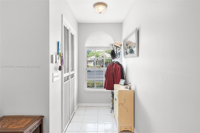3171 Holiday Springs Blvd Unit 31-5, Margate, FL 33063 - hallway with light tile patterned flooring and baseboards