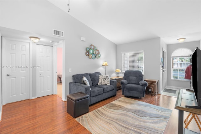 3171 Holiday Springs Blvd Unit 31-5, Margate, FL 33063 - living area with baseboards, visible vents, wood finished floors, and lofted ceiling