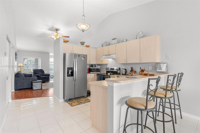 3171 Holiday Springs Blvd Unit 31-5, Margate, FL 33063 - kitchen with light countertops, a peninsula, stainless steel appliances, light brown cabinets, and under cabinet range hood