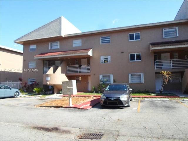 view of property featuring uncovered parking