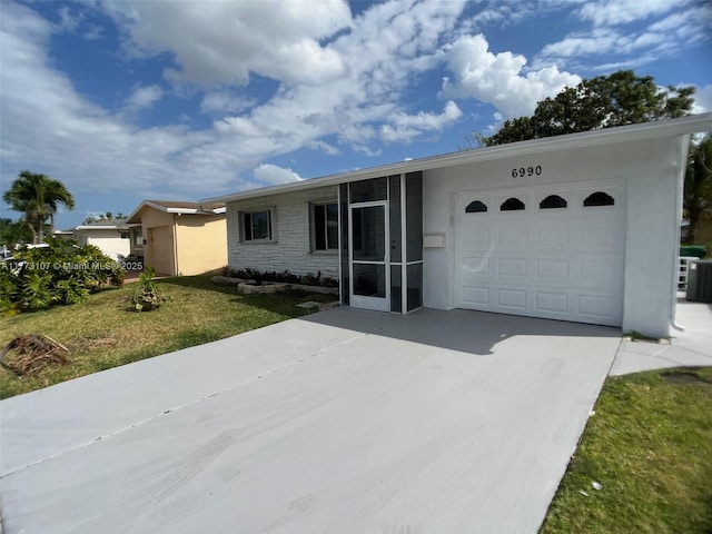 6990 NW 17th St, Margate, FL 33063 - ranch-style home with stone siding, a garage, stucco siding, a front yard, and driveway
