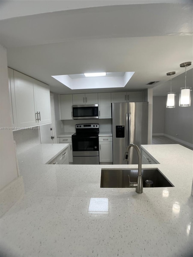 6990 NW 17th St, Margate, FL 33063 - kitchen with a sink, pendant lighting, visible vents, light stone countertops, and appliances with stainless steel finishes
