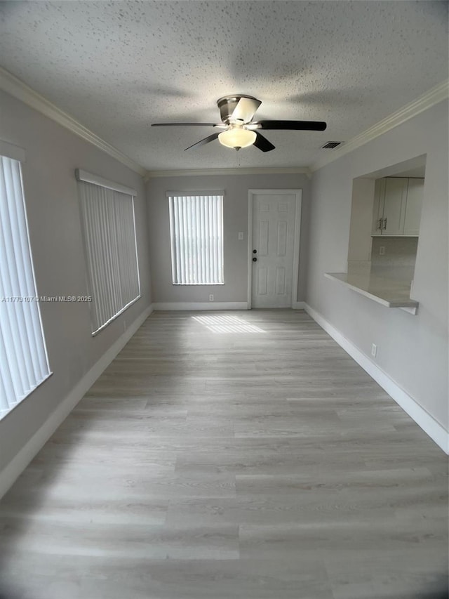 6990 NW 17th St, Margate, FL 33063 - unfurnished living room with light wood-type flooring, ceiling fan, ornamental molding, and a textured ceiling