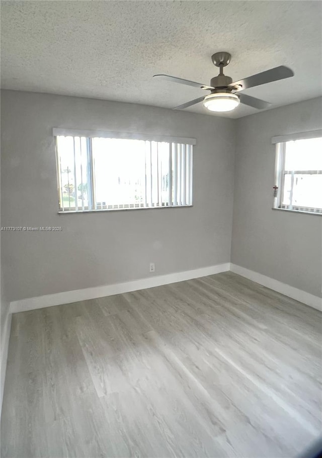 6990 NW 17th St, Margate, FL 33063 - empty room featuring a textured ceiling, baseboards, ceiling fan, and wood finished floors