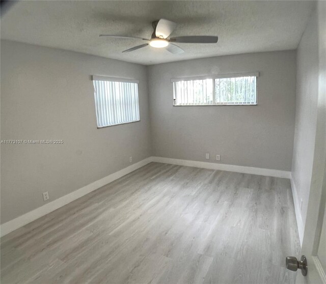 6990 NW 17th St, Margate, FL 33063 - spare room with baseboards, wood finished floors, and a textured ceiling
