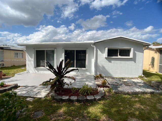 6990 NW 17th St, Margate, FL 33063 - rear view of property featuring stucco siding