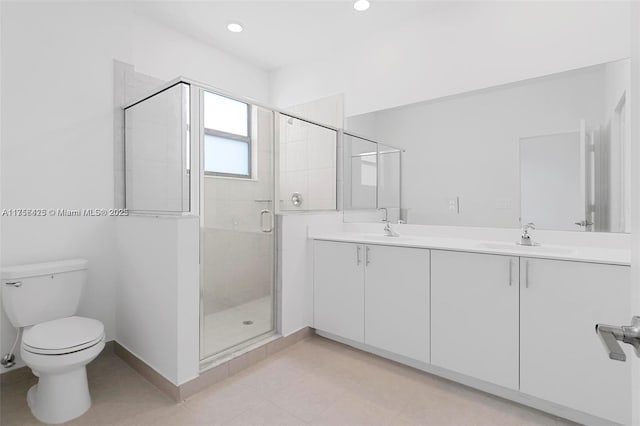 full bath with toilet, a sink, double vanity, and a shower stall