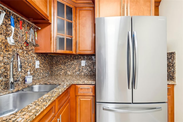 1849 S Ocean Dr Unit 711, Hallandale Beach, FL 33009 - kitchen with freestanding refrigerator, a sink, backsplash, and brown cabinetry