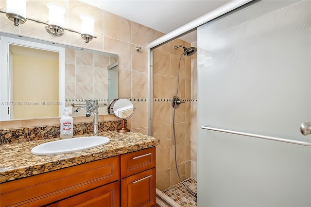 1849 S Ocean Dr Unit 711, Hallandale Beach, FL 33009 - bathroom with a stall shower, vanity, and tile walls