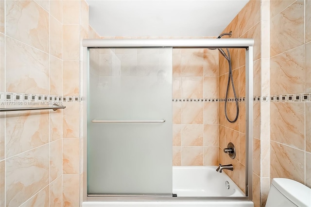 1849 S Ocean Dr Unit 711, Hallandale Beach, FL 33009 - bathroom featuring toilet, shower / bath combination with glass door, and tile walls