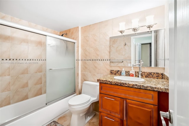 1849 S Ocean Dr Unit 711, Hallandale Beach, FL 33009 - full bathroom with tile walls, vanity, toilet, and combined bath / shower with glass door