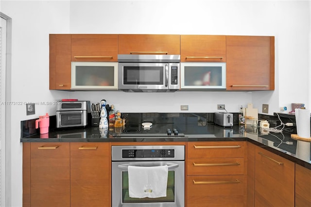 244 Biscayne Blvd Unit 206, Miami, FL 33132 - kitchen featuring stainless steel appliances, brown cabinetry, glass insert cabinets, and modern cabinets