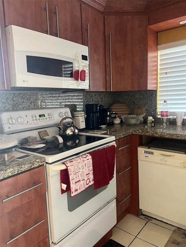 1100 Colony Point Cir Unit 201, Pembroke Pines, FL 33026 - kitchen featuring white appliances, backsplash, light tile patterned flooring, and dark stone countertops