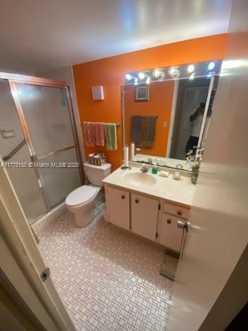 1100 Colony Point Cir Unit 201, Pembroke Pines, FL 33026 - bathroom featuring a stall shower, vanity, and toilet