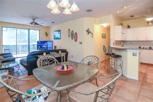 85 Gulfstream Rd Unit 304A, Dania Beach, FL 33004 - dining room featuring a ceiling fan, light tile patterned floors, a chandelier, and baseboards