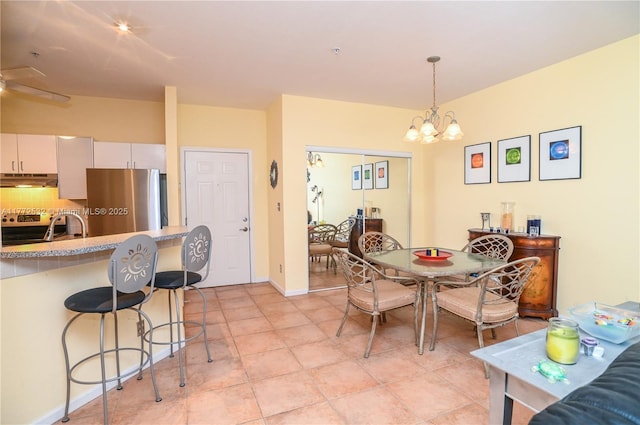 85 Gulfstream Rd Unit 304A, Dania Beach, FL 33004 - dining room featuring a chandelier, a ceiling fan, and baseboards