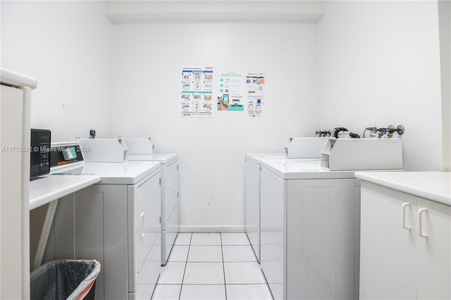 85 Gulfstream Rd Unit 304A, Dania Beach, FL 33004 - community laundry featuring washing machine and dryer, light tile patterned floors, and baseboards