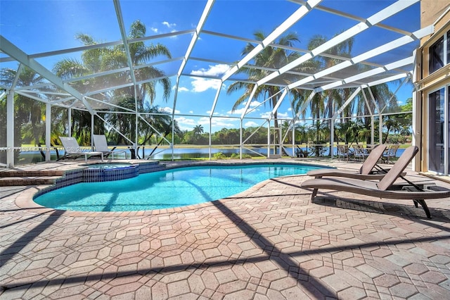 view of swimming pool with a pool with connected hot tub, a lanai, and a patio area