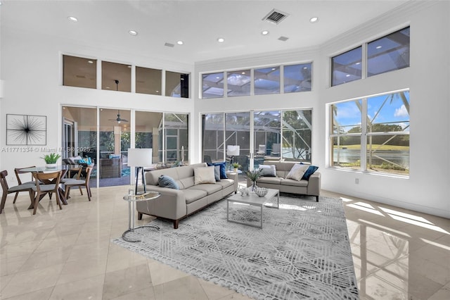 living area with visible vents, a high ceiling, and recessed lighting
