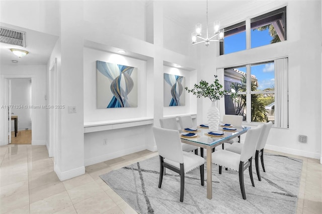tiled dining room with baseboards, a towering ceiling, visible vents, and a chandelier