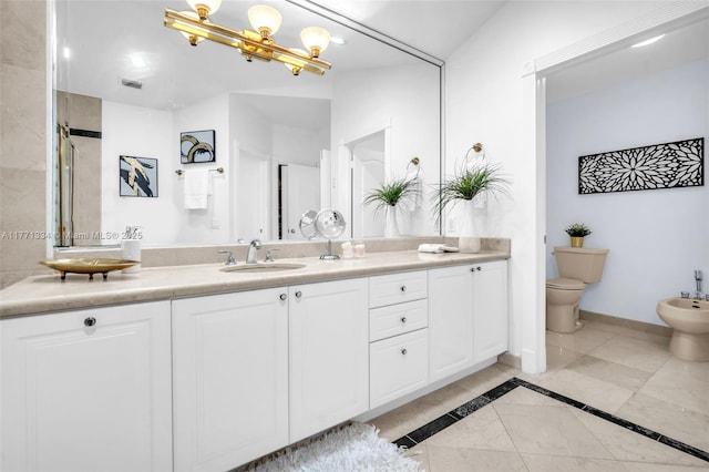 full bath with toilet, vanity, baseboards, and a bidet