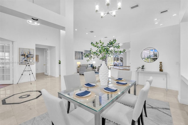 dining room featuring a notable chandelier, baseboards, visible vents, a towering ceiling, and recessed lighting