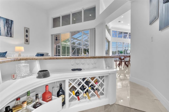 wine room featuring baseboards and tile patterned flooring