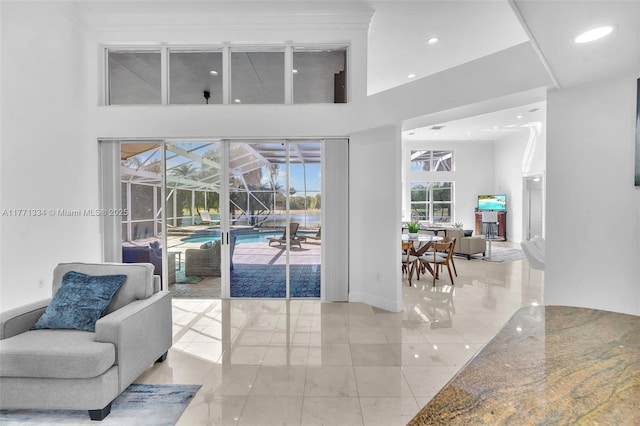 interior space featuring a towering ceiling and recessed lighting