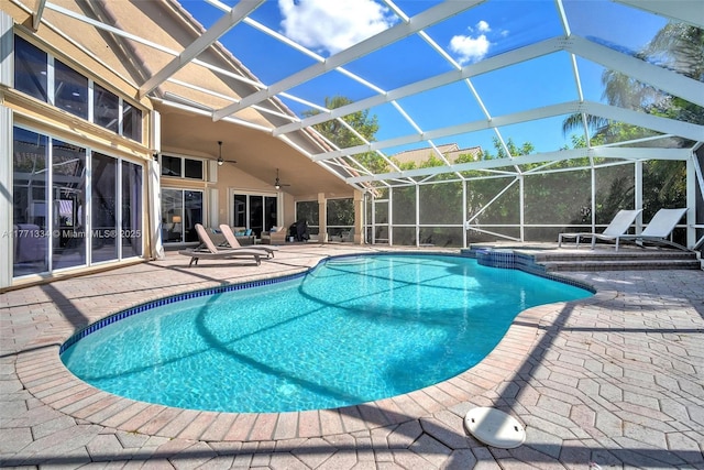 view of swimming pool featuring a ceiling fan, a pool with connected hot tub, a lanai, and a patio area