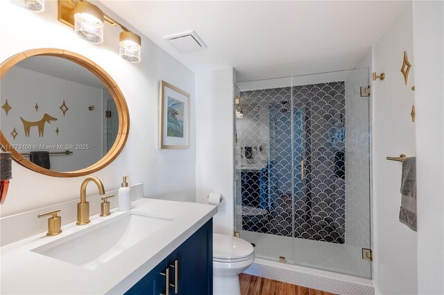 full bathroom with a stall shower, visible vents, toilet, and vanity