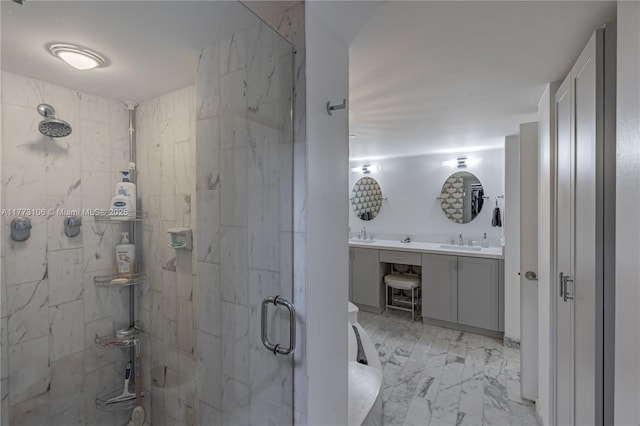 bathroom featuring a stall shower, double vanity, marble finish floor, and a sink