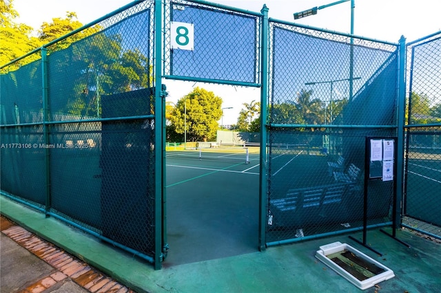 view of tennis court featuring fence
