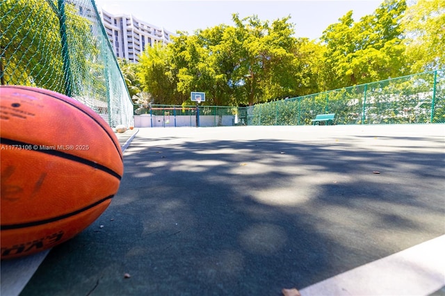 view of basketball court featuring fence and community basketball court