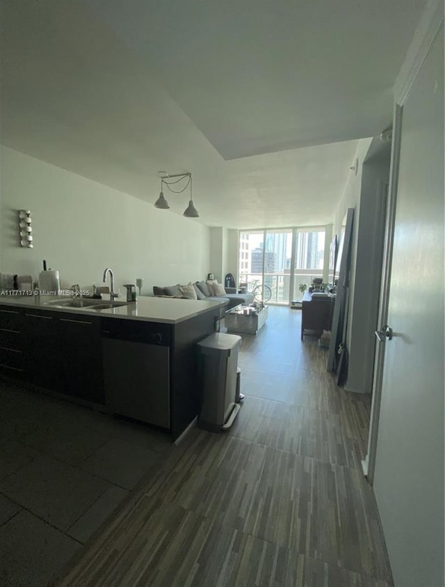55 SE 6th St Unit 1506, Miami, FL 33131 - kitchen featuring open floor plan, dark wood-style flooring, stainless steel dishwasher, a sink, and dark cabinets