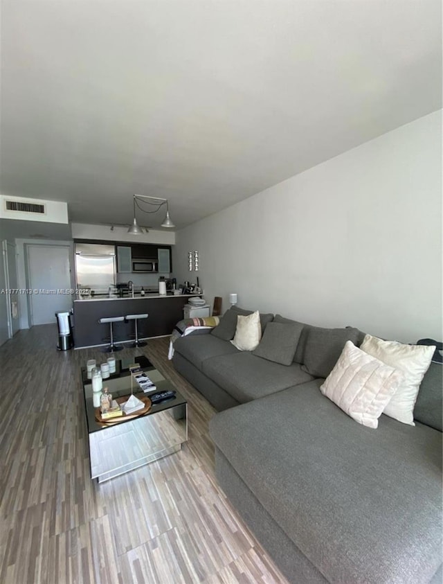 55 SE 6th St Unit 1506, Miami, FL 33131 - living room featuring visible vents and wood finished floors