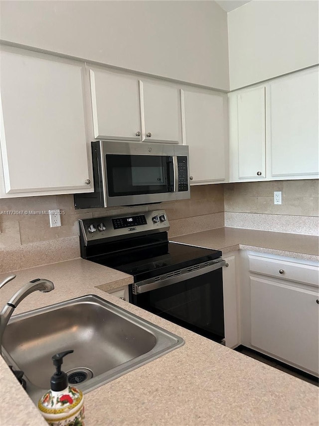 2445 SW 18th Ter Unit 1119, Fort Lauderdale, FL 33315 - kitchen featuring light countertops, a sink, white cabinets, and stainless steel appliances