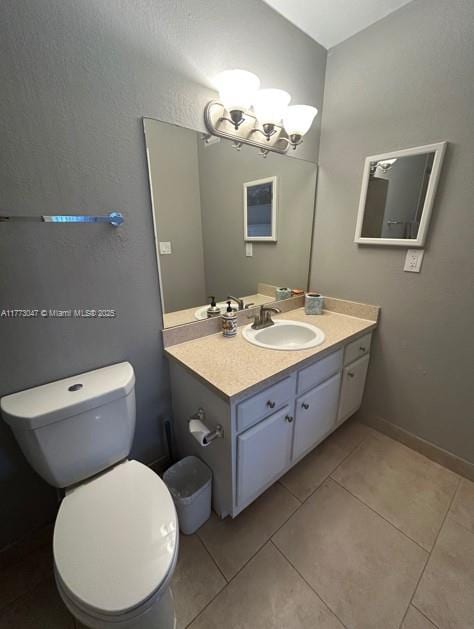 2445 SW 18th Ter Unit 1119, Fort Lauderdale, FL 33315 - bathroom featuring baseboards, an inviting chandelier, toilet, vanity, and tile patterned floors