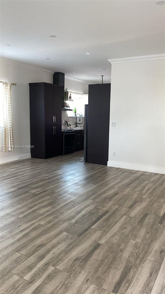 11845 SW 3rd St, Miami, FL 33184 - unfurnished living room featuring baseboards, ornamental molding, wood finished floors, and a sink