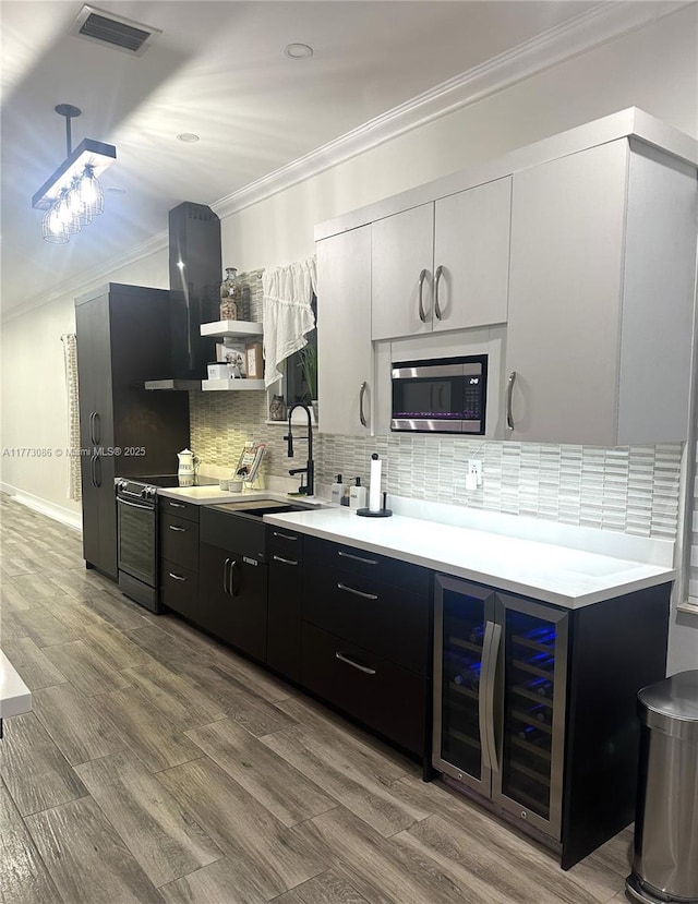 11845 SW 3rd St, Miami, FL 33184 - kitchen with stainless steel microwave, crown molding, a sink, range with electric cooktop, and visible vents