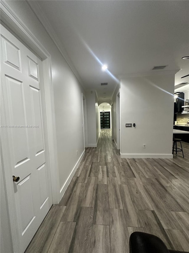 11845 SW 3rd St, Miami, FL 33184 - hallway featuring crown molding, baseboards, wood finished floors, and arched walkways