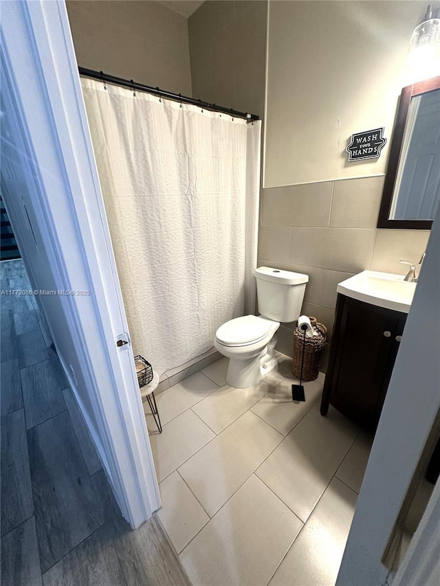 11845 SW 3rd St, Miami, FL 33184 - full bath with tile walls, toilet, vanity, tile patterned flooring, and wainscoting