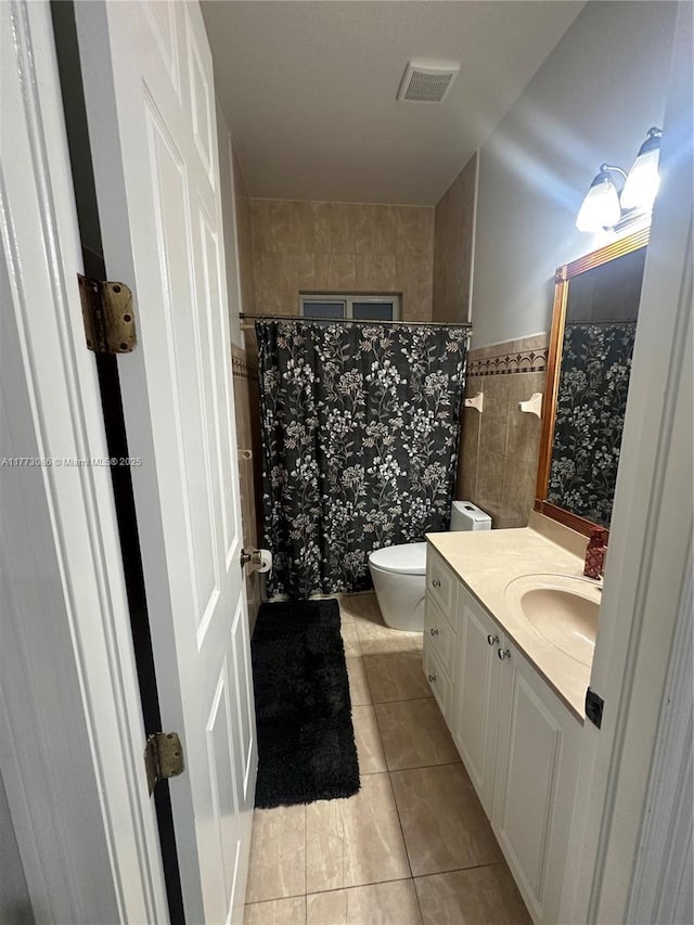 11845 SW 3rd St, Miami, FL 33184 - full bathroom featuring tile patterned flooring, tile walls, toilet, a wainscoted wall, and visible vents