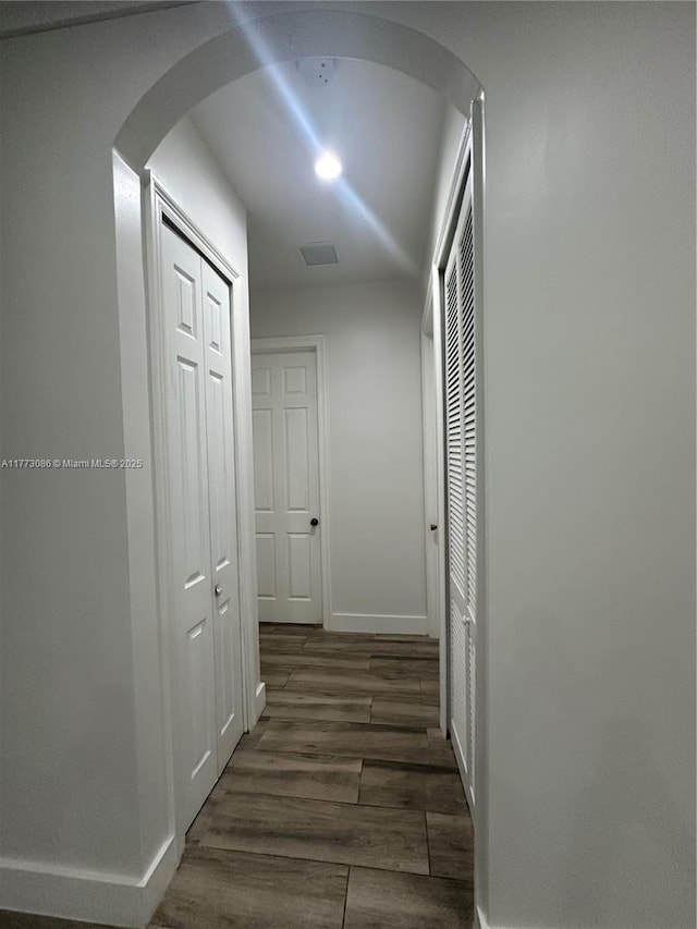 11845 SW 3rd St, Miami, FL 33184 - hallway featuring arched walkways, dark wood-style floors, baseboards, and visible vents