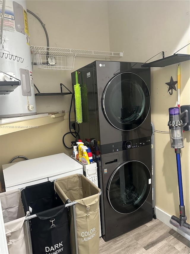 11845 SW 3rd St, Miami, FL 33184 - laundry room featuring stacked washer / dryer, electric water heater, laundry area, and wood finished floors