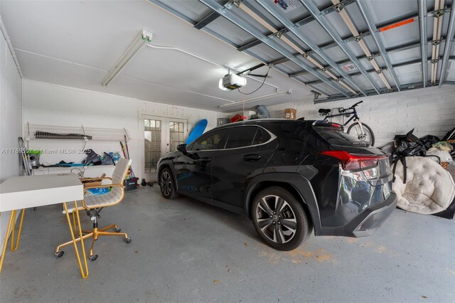 1401 NE 9th St Unit 26, Fort Lauderdale, FL 33304 - garage with a garage door opener and french doors
