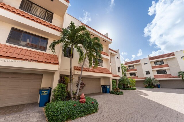 1401 NE 9th St Unit 26, Fort Lauderdale, FL 33304 - view of property featuring decorative driveway and an attached garage