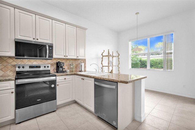 6843 Montrose Way, Boynton Beach, FL 33437 - kitchen with appliances with stainless steel finishes, a sink, decorative backsplash, a peninsula, and light tile patterned floors