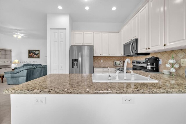 6843 Montrose Way, Boynton Beach, FL 33437 - kitchen with stainless steel appliances, light stone counters, a peninsula, ceiling fan, and recessed lighting
