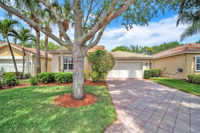 6843 Montrose Way, Boynton Beach, FL 33437 - view of front facade featuring a garage, stucco siding, driveway, and a tiled roof